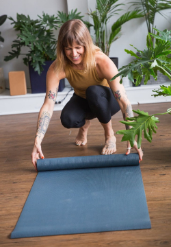 Jaime Moar setting up a yoga mat