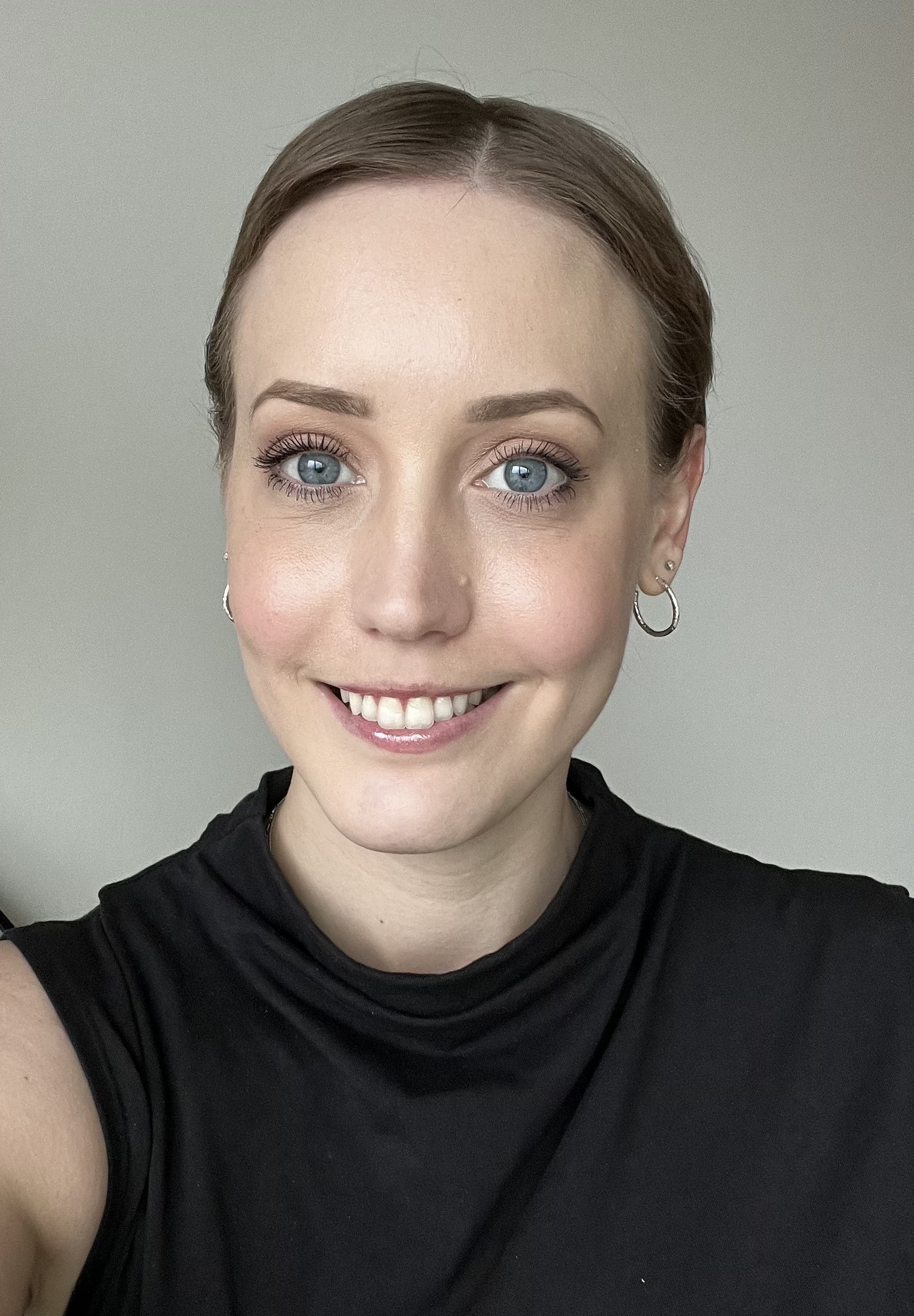 A headshot of ashley, smiling.