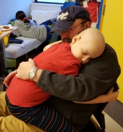 Ollie hugging his father