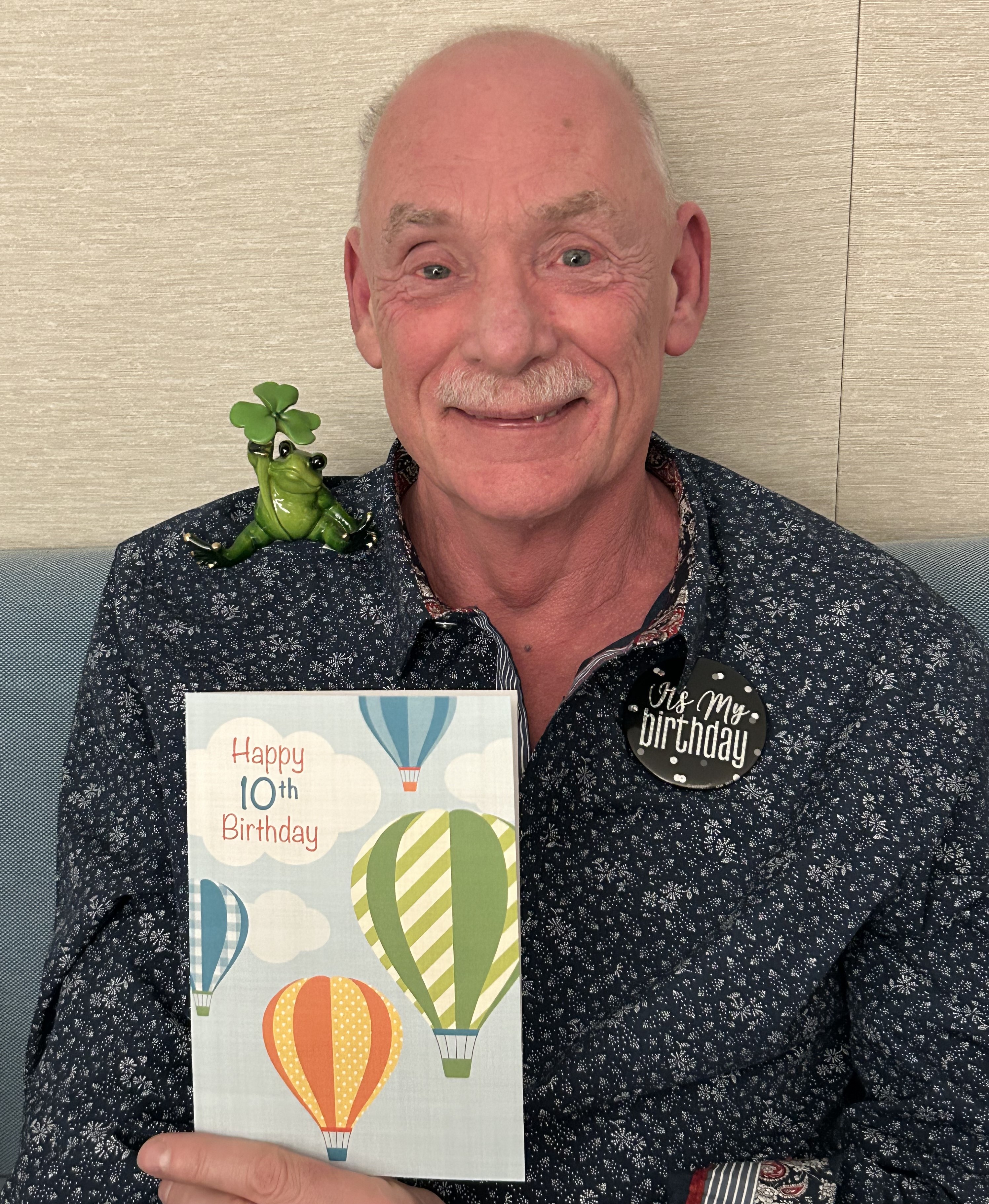 A man holds a 10th birthday card to celebrate his stem cell transplant anniversary
