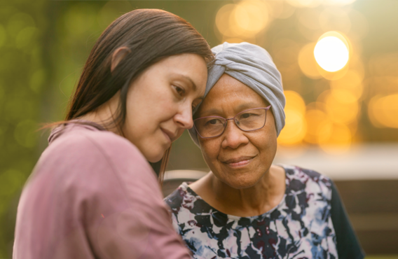 A younger woman holding an older woman