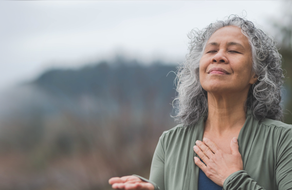 A woman with her hand to her heart