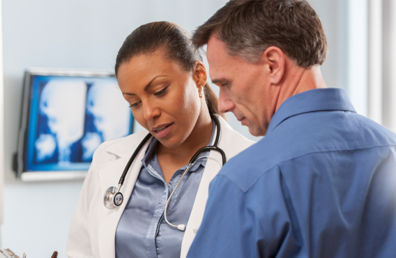 A male and female doctor viewing test results.