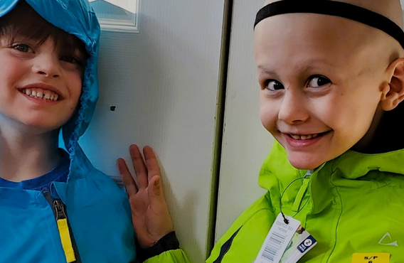 Two children in colorful jackets standing by a door, with “MATCH X4” and Leukemia & Lymphoma Society of Canada campaign text on the right.