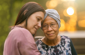 A younger woman holding an older woman