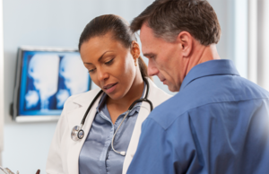 A male and female doctor viewing test results.