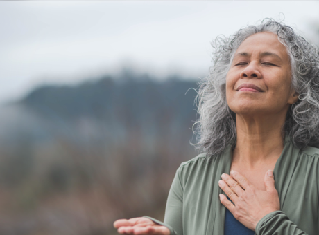 A woman with her hand to her heart