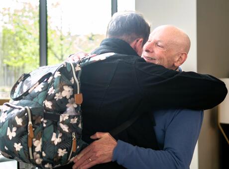 Rob Neander and Tom Marshall meeting and hugging for the first time.