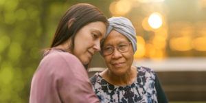 A younger woman holding an older woman