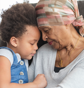 Grandmother with cancer and child hugging