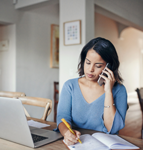 Woman at desk on phone