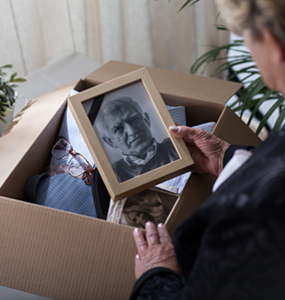 An old woman staring at a picture of husband