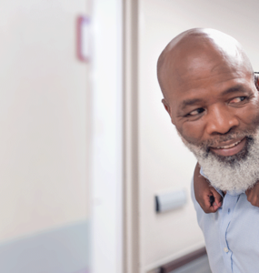 An old man giving a piggy-back to his grandson