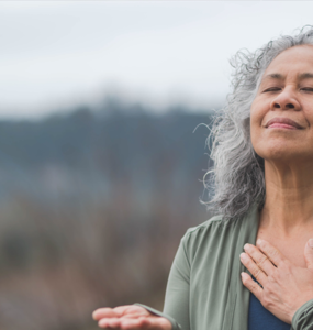 A woman with her hand to her heart