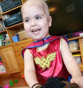 Amelia smiling while playing with a toy