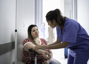 Doctor assisting a patient with a blood pressure machine