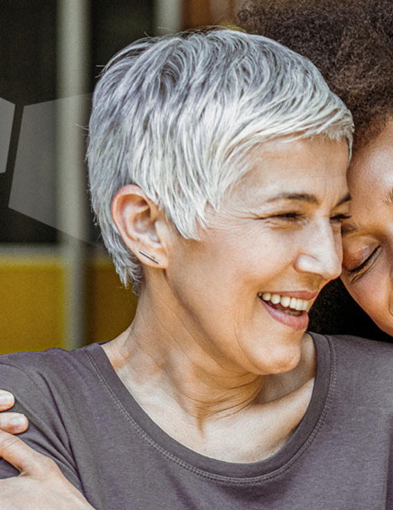Two women hugging and smiling