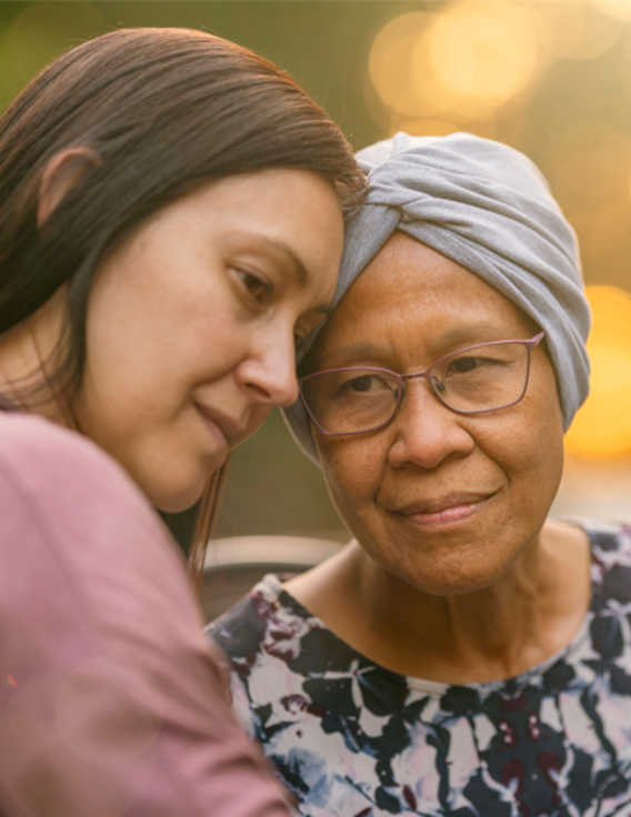 A younger woman holding an older woman