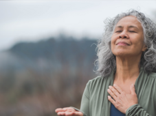 A woman with her hand to her heart