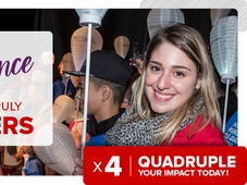 An image of Alysssa smiling while holding up a white lantern with a group of people. Overlayed with the text: &quot;Make a difference where it truly matters. 4x Quadruple your impact today!&quot;