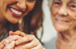 Two women holding hands and smiling